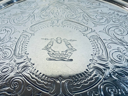 KLS Vaults Victorian sterling silver salver featuring intricate chased acanthus leaf patterns and a central crest.
