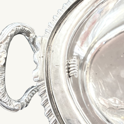 KLS Vaults Victorian silver soup tureen featuring ornate leaf-capped scroll handles and a detailed gadrooned rim.