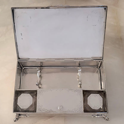 KLS Vaults mid-Victorian sterling silver standish with chased foliate borders, Rococo feet, and crystal inkwells.