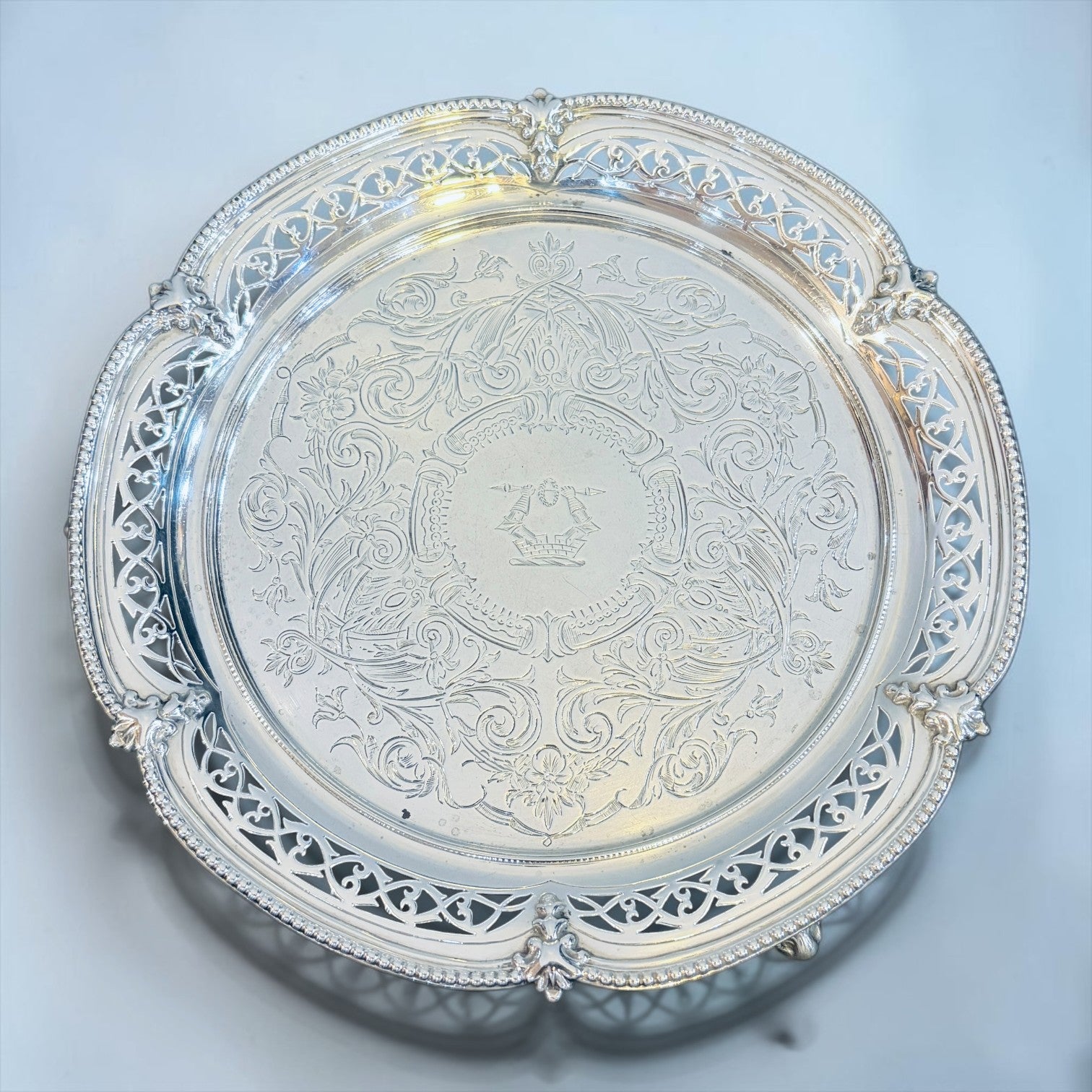 KLS Vaults Victorian sterling silver salver with intricate chased floral motifs, pierced gallery, and family crest.