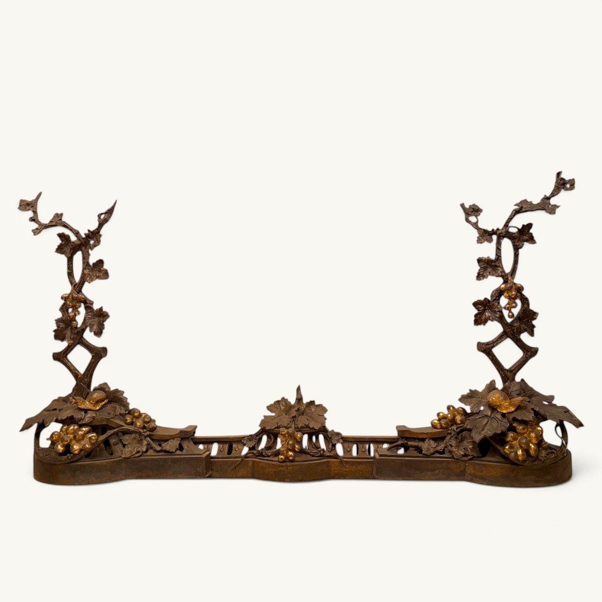 Victorian parcel-gilt bronze fireplace fender with naturalistic grapevine and snail motifs.