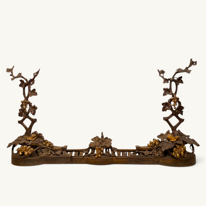 Victorian parcel-gilt bronze fireplace fender with naturalistic grapevine and snail motifs.